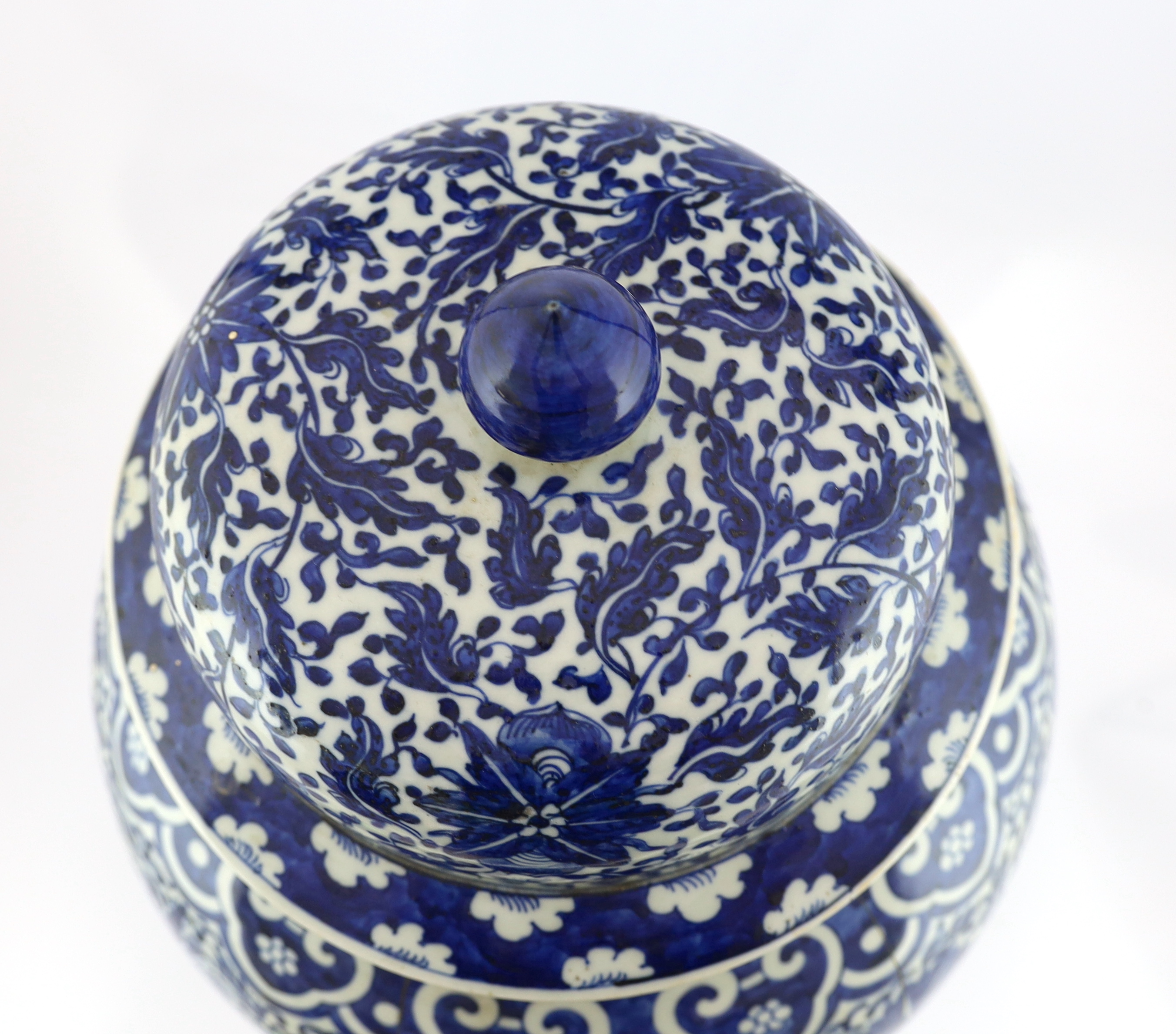 A massive Chinese blue and white ‘lotus’ vase and cover, 18th/19th century, broken and glued